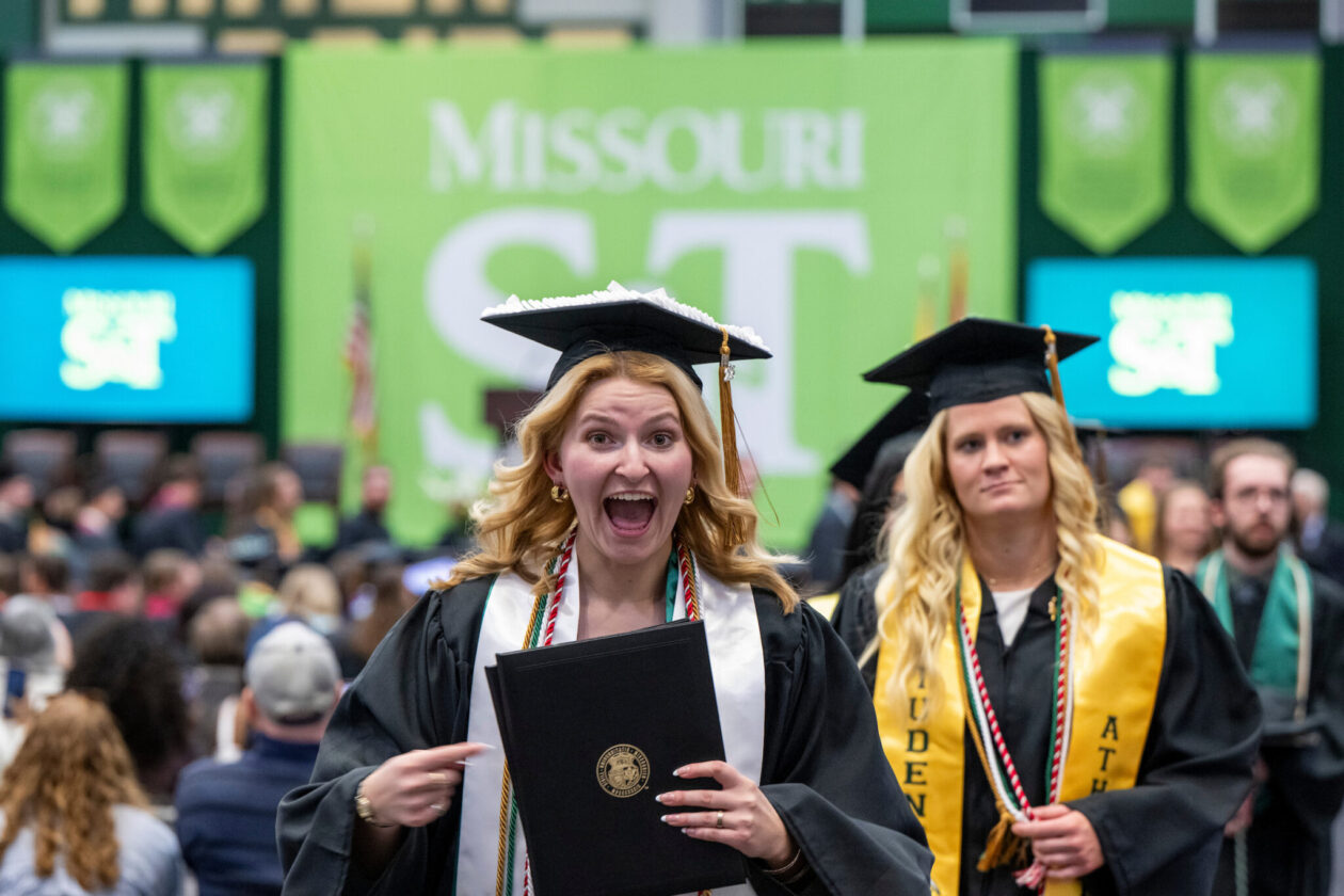 Happy graduates leaving arena.