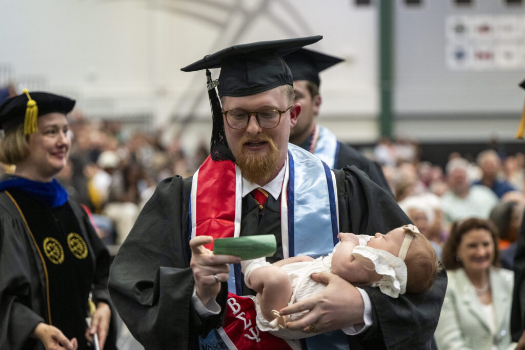Maxwell and Milena Gessert wait their turn to cross the commencement stage. Photo by Michael Pierce/Missouri S&T