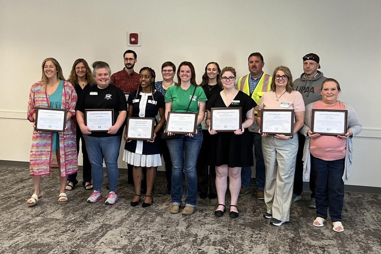 Staff and student employees pose with their certificates.