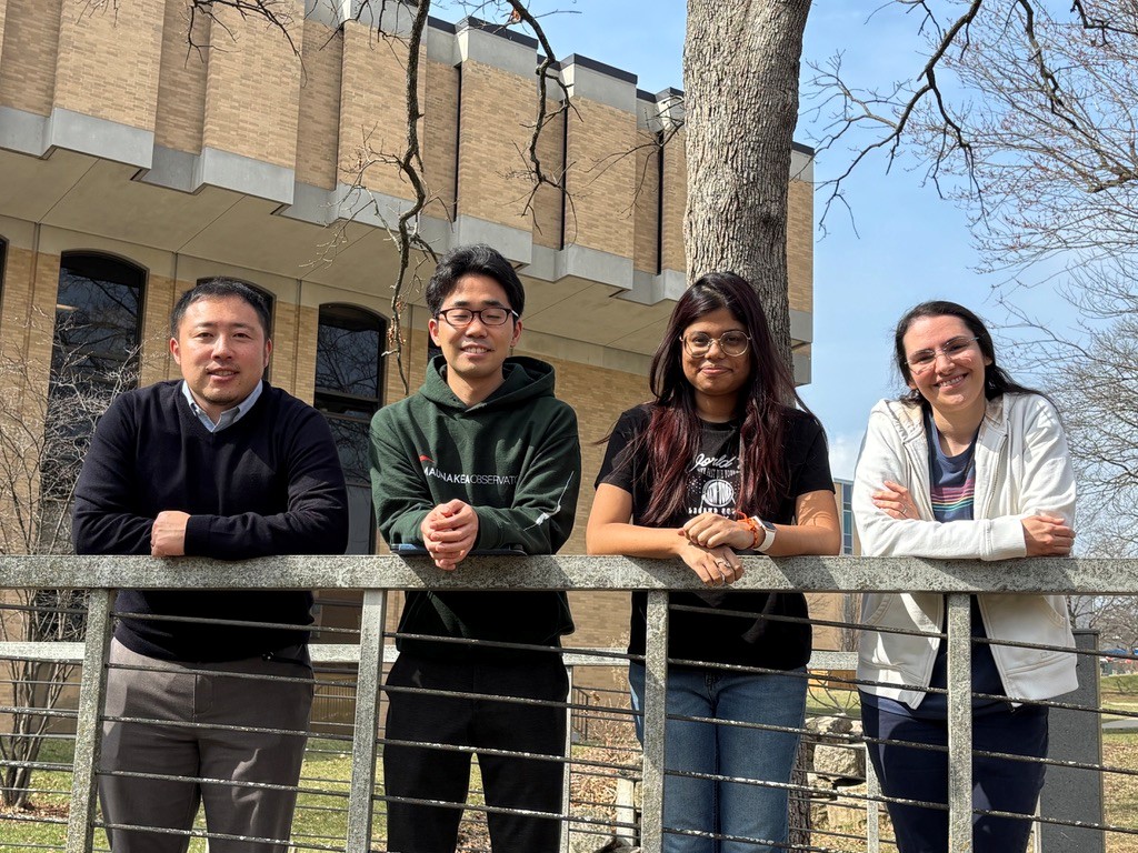 Four people standing outdoors on the S&T campus.