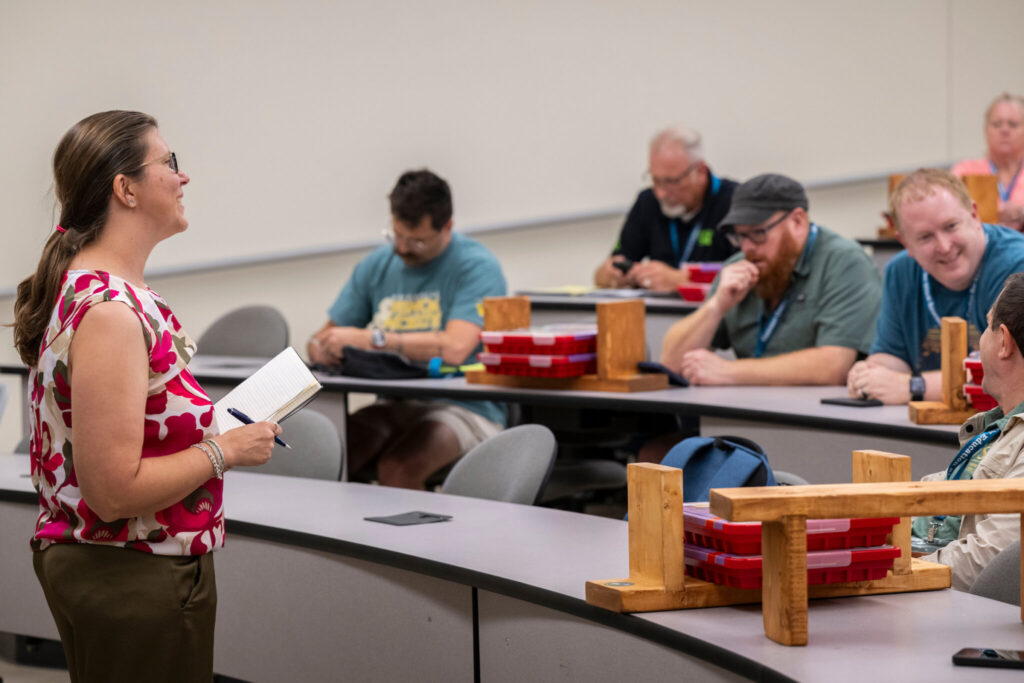 Teacher leads a class with adult learners.
