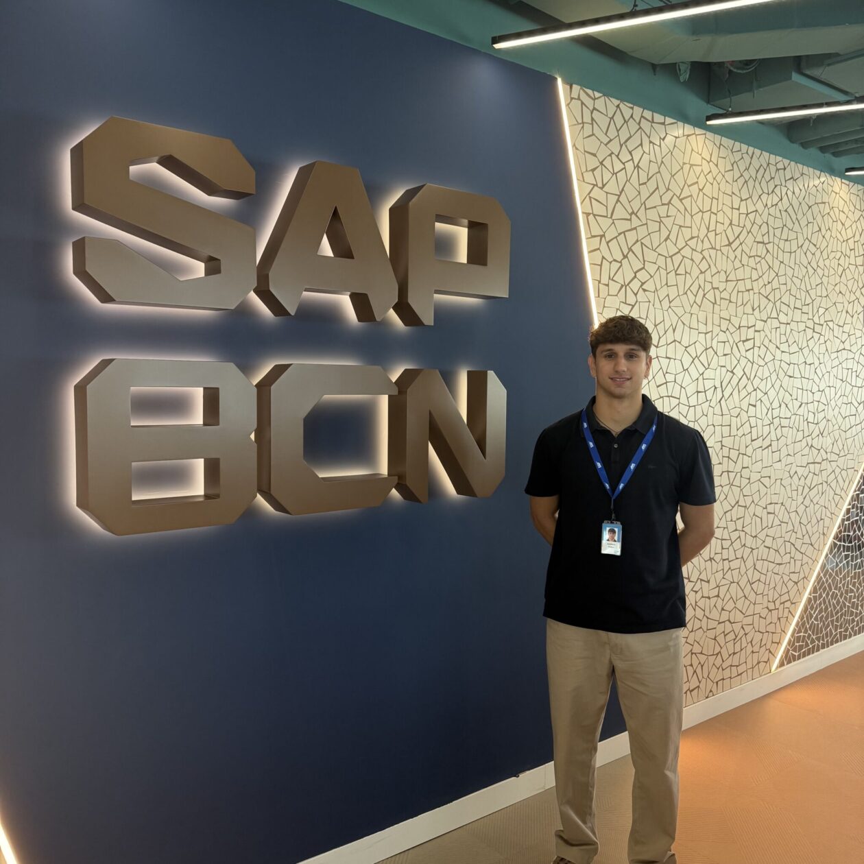 Giorgio Panci in front of a sign that says "SAP BCN."