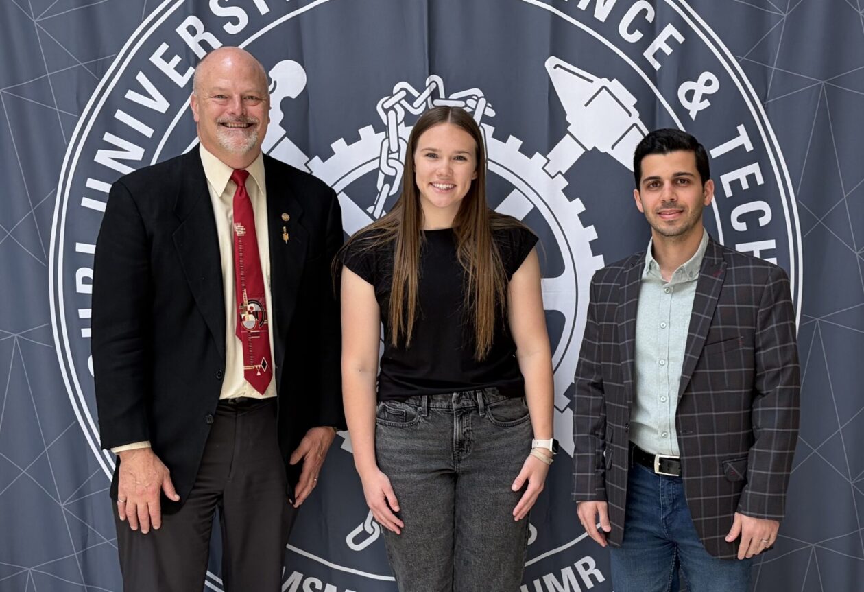 From left, Dr. Joel Burken, Emma Eberhart and Mohammad Afsharmovahed stand in front of a Missouri S&T backdrop in Butler-Carlton Hall. Photo courtesy of Burken